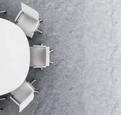 blackand white picture of roundtable with chairs around it