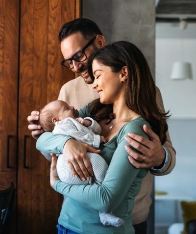 young couple holding newborn