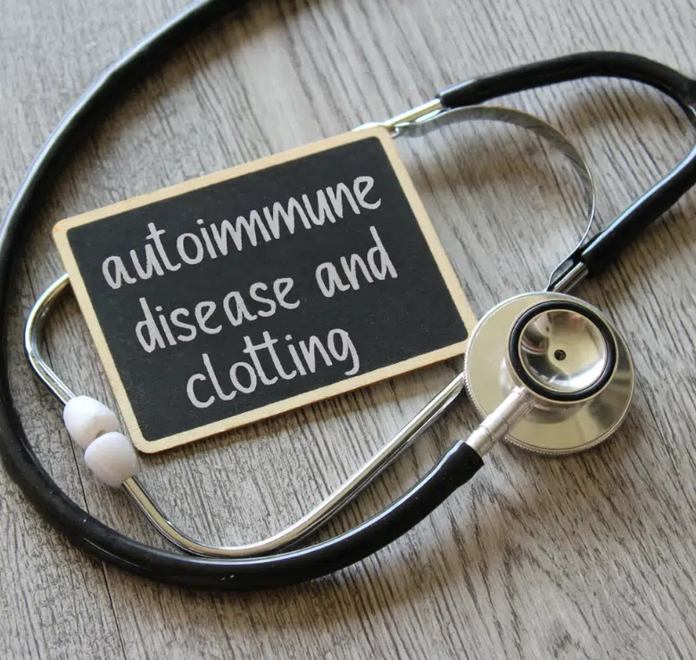 sign that reads "autoimmune disease and clotting" that is draped by a stethoscope