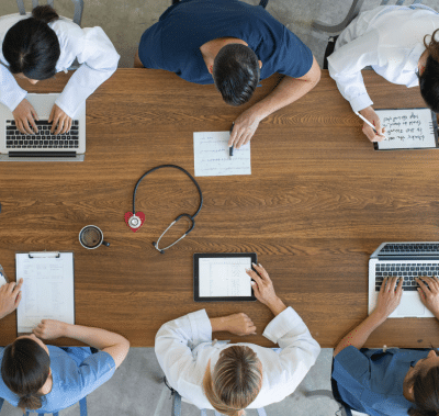overhead view of healthcare professionals including men and women at a table