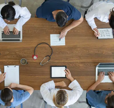 overhead view of healthcare professionals including men and women at a table