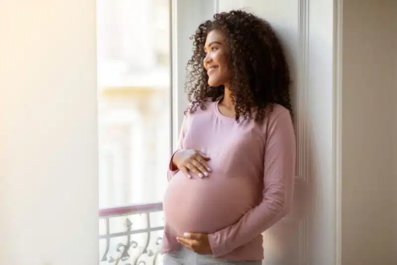 pregnant woman looking out window