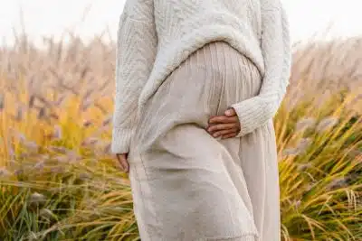 pregnant woman walking in a field